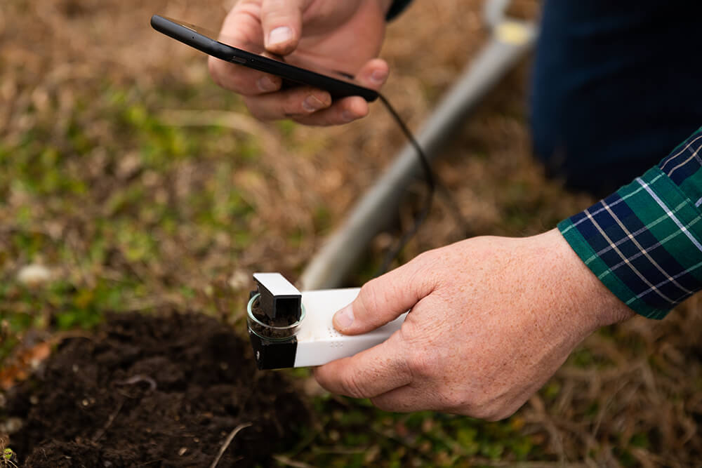 Rancher uses a smart phone device to test soil organic matter