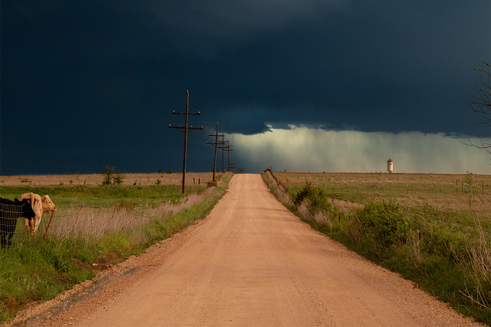 Storm looms over a farm road