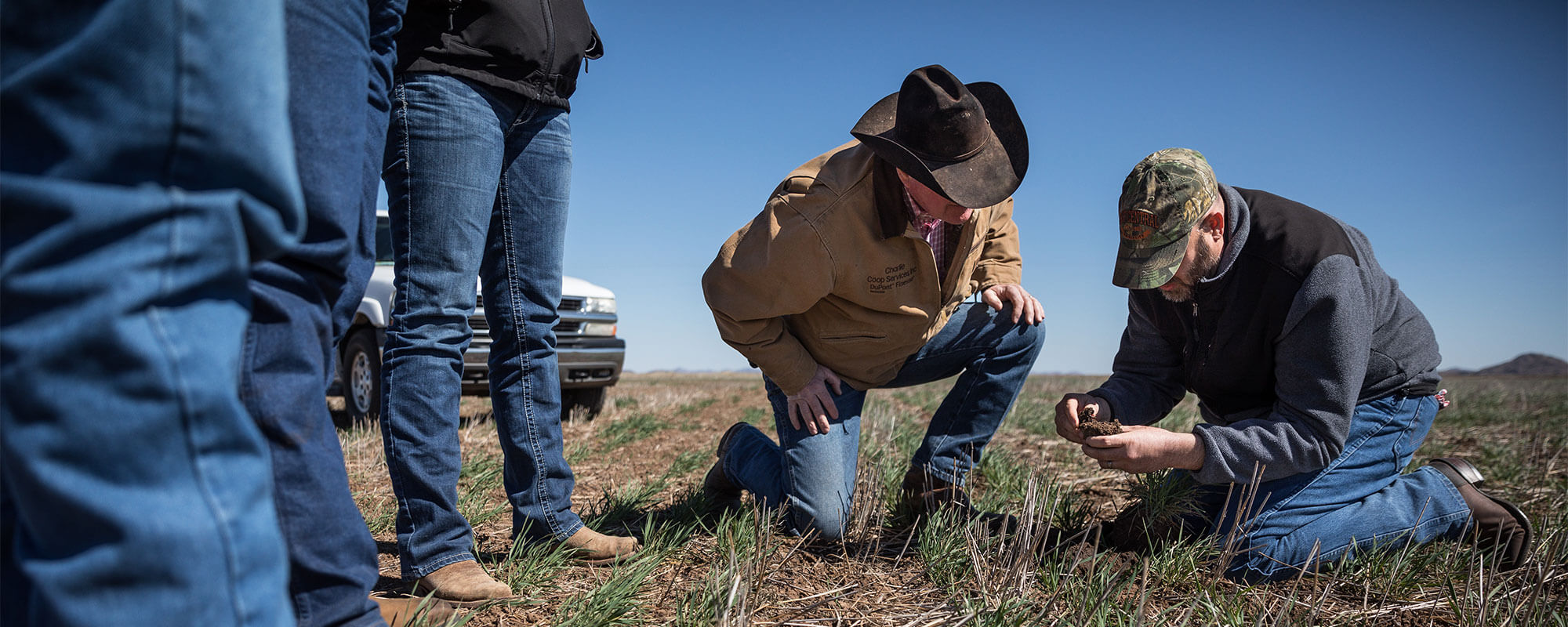 Ranchers examining the soil