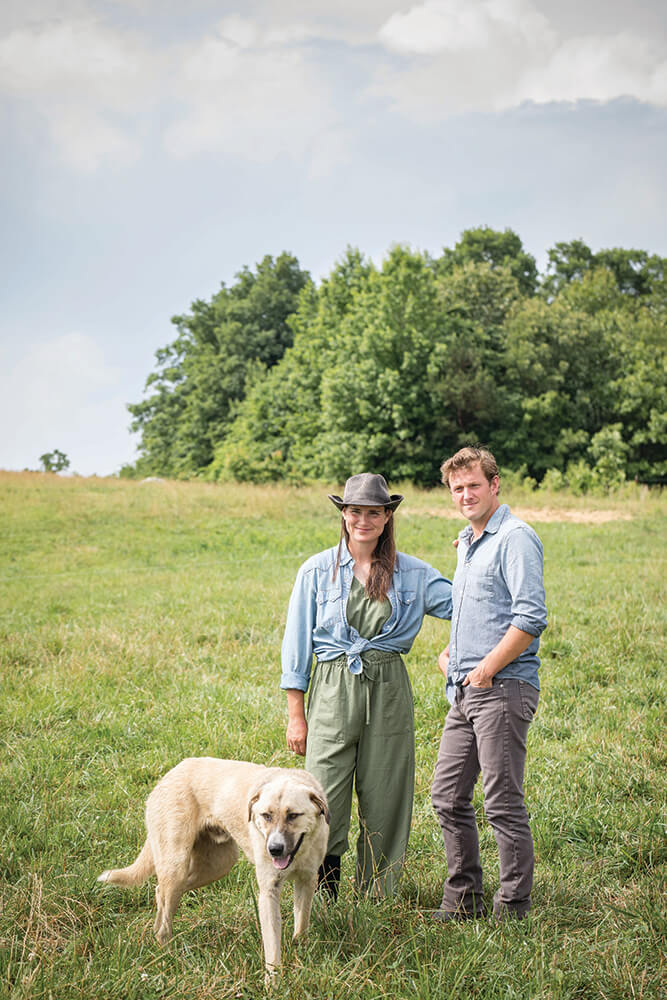 Andrea Todt and Cody Hopkins in pasture with their dog