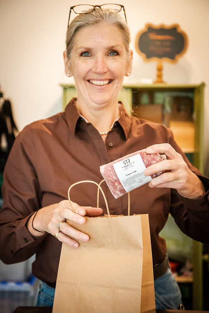 Christine Martin shows the ground lamb meat produced on her operation