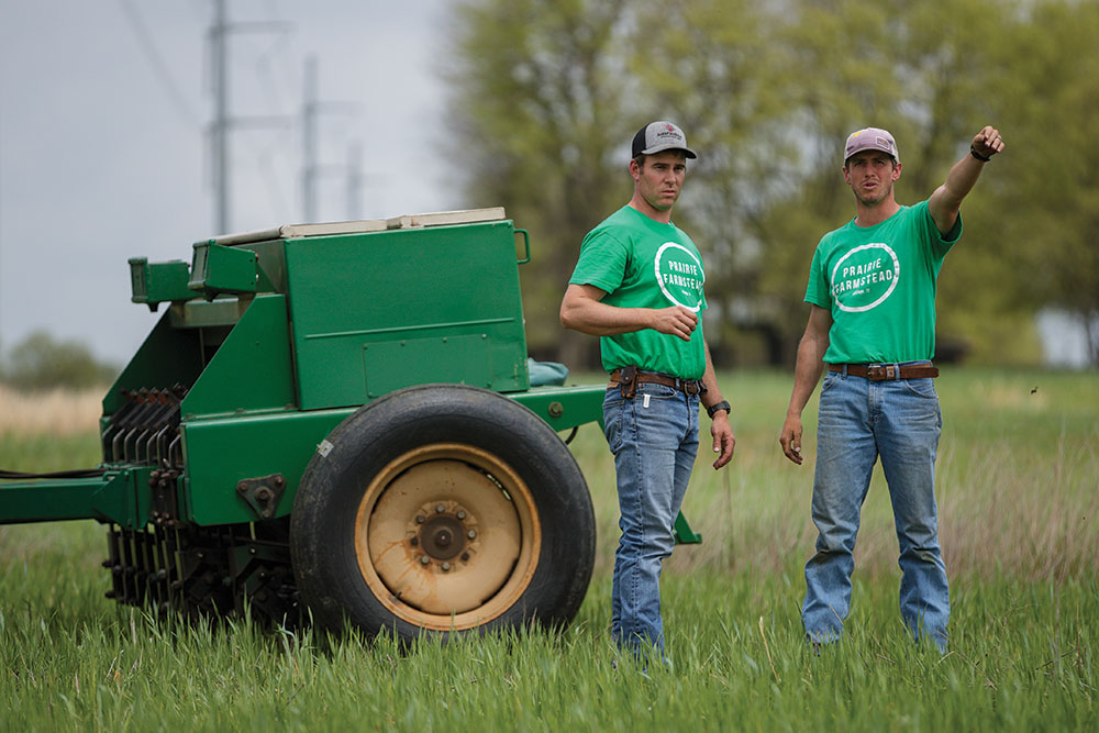 Chuck Trowbridge and Tucker Nickols discuess crop planting at no-till drill
