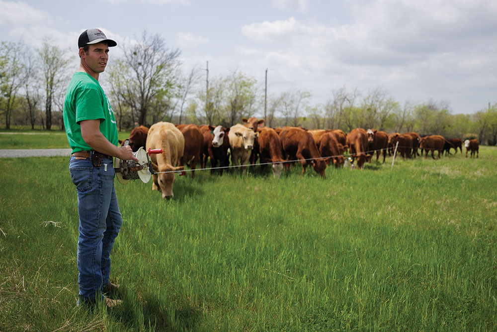 Chuck Trowbridge unrolls electric fence for cattle move