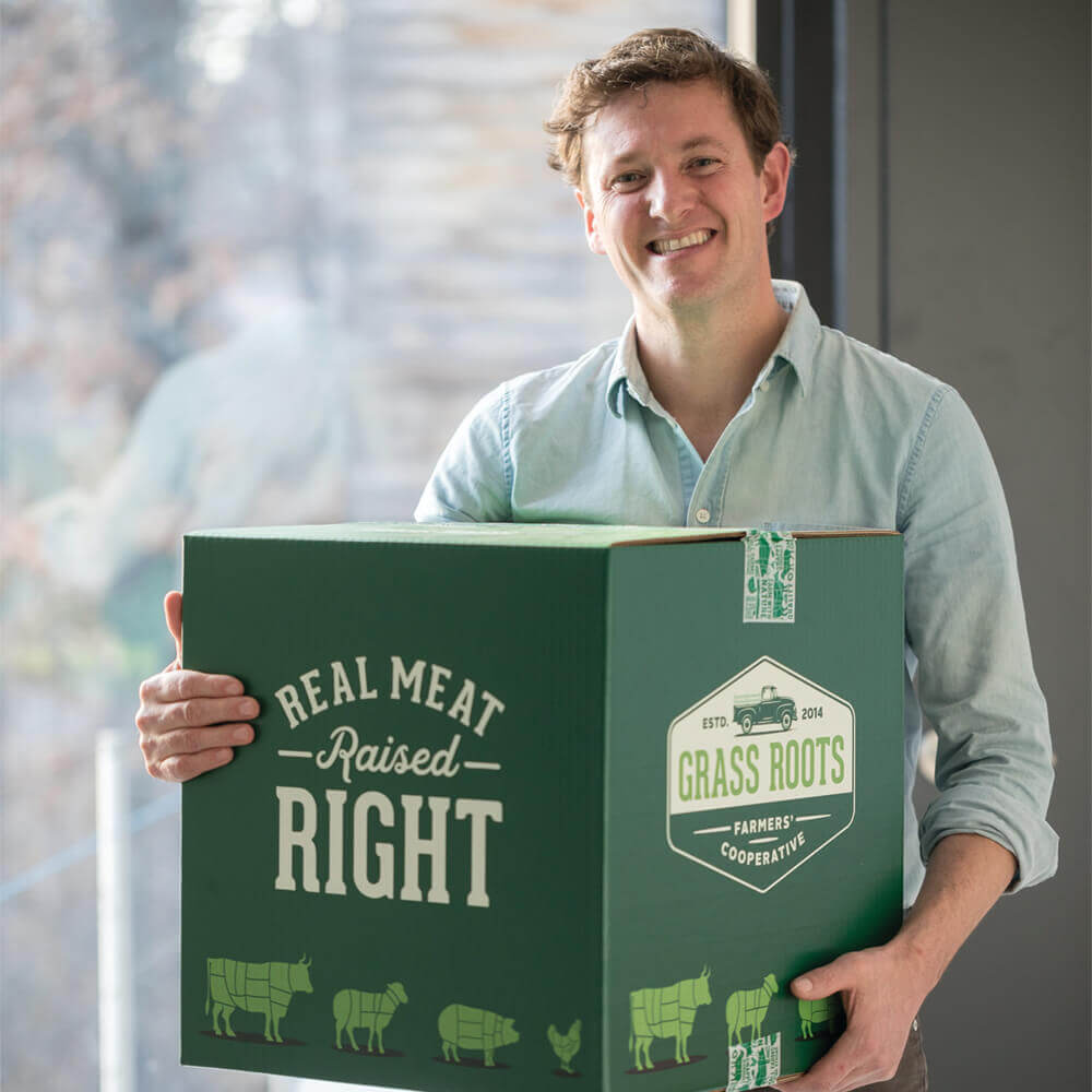 Cody Hopkins holds a box of beef