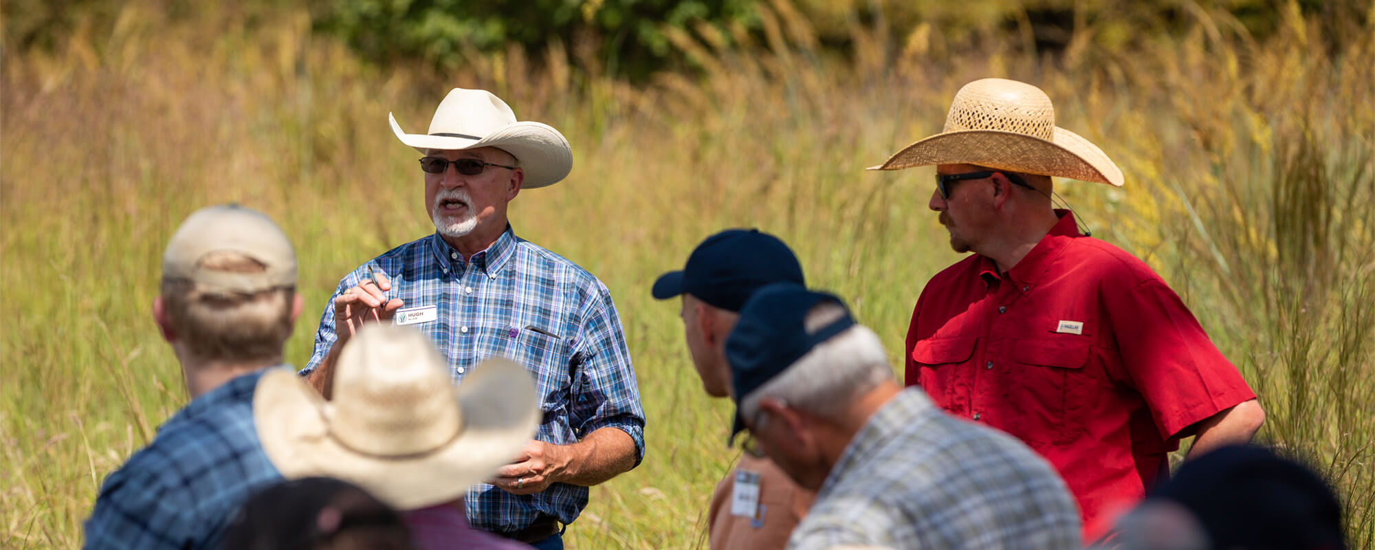 Hugh Aljoe, Noble's Director of Producer Relations, and Joe Pokay, Noble's General Ranch Manager, speak with a rancher group on a tour of Noble Research Institute's Red River Ranch.