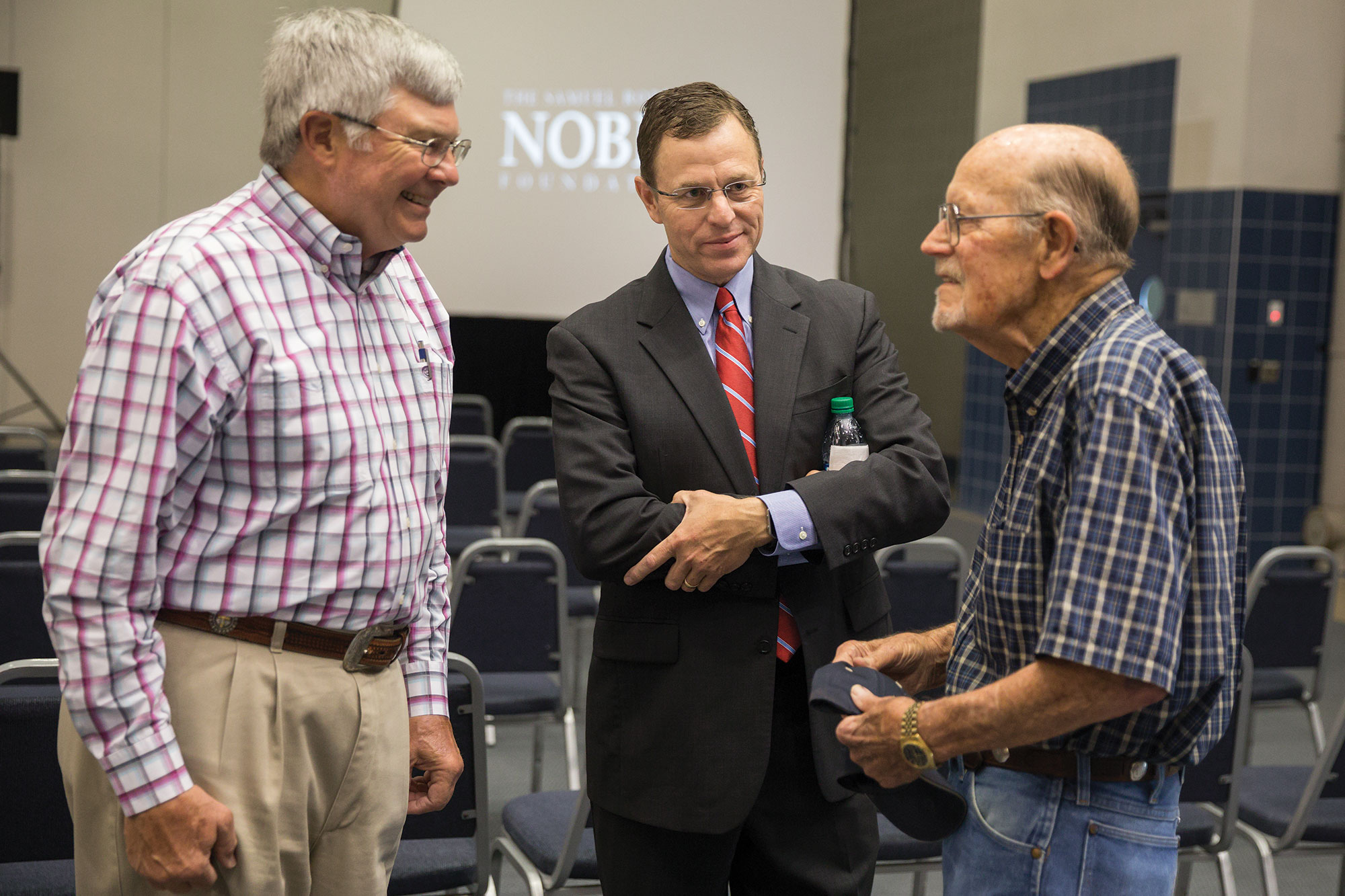 Steve Rhines (center) listens to Noble retirees Fred Schmedt (left) and Gary Simmons following the announcement that the Noble Foundation would be renamed as the Noble Research Institute.