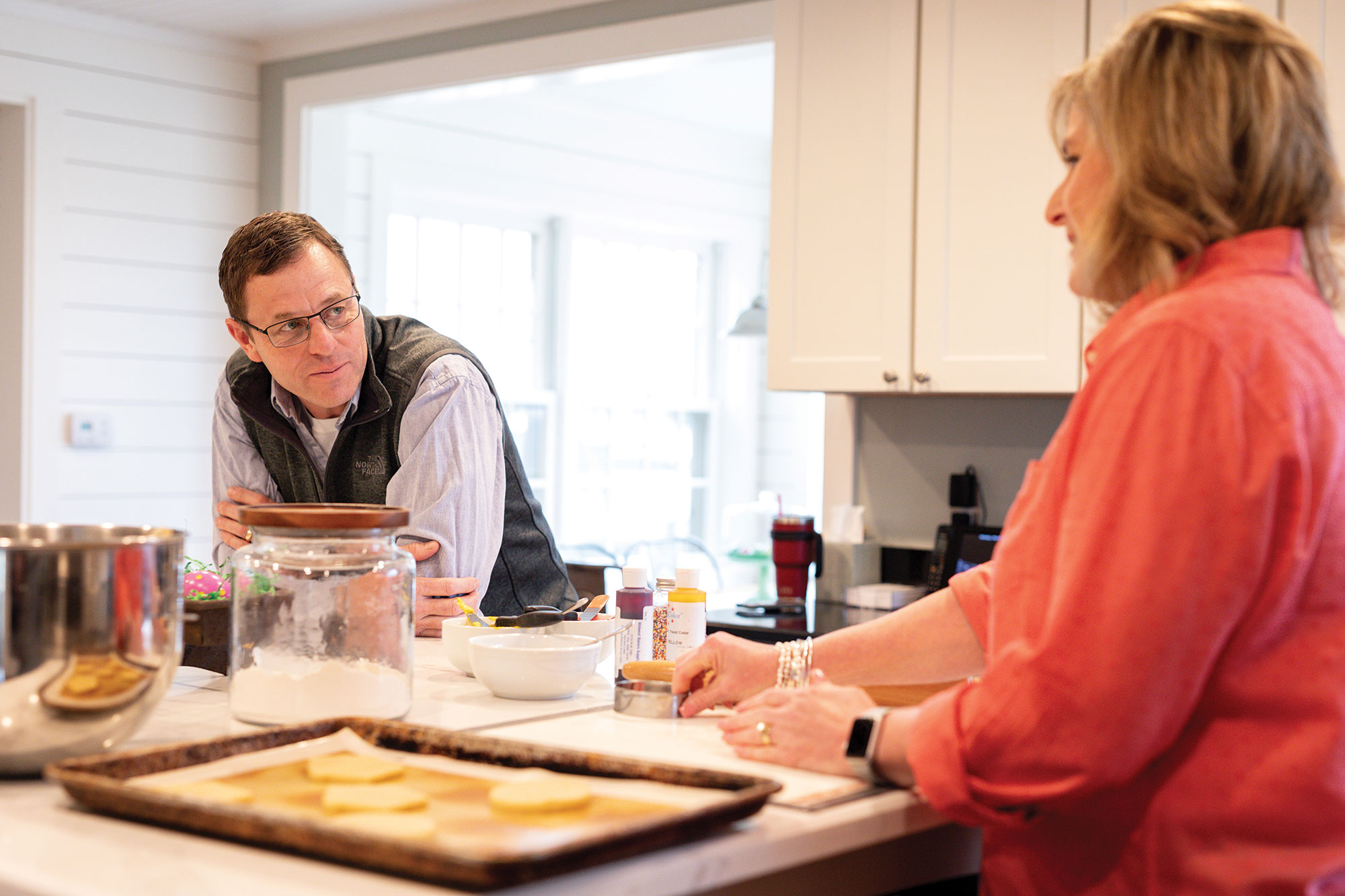 Steve and Debbie Rhines enjoy time together in their kitchen at home.