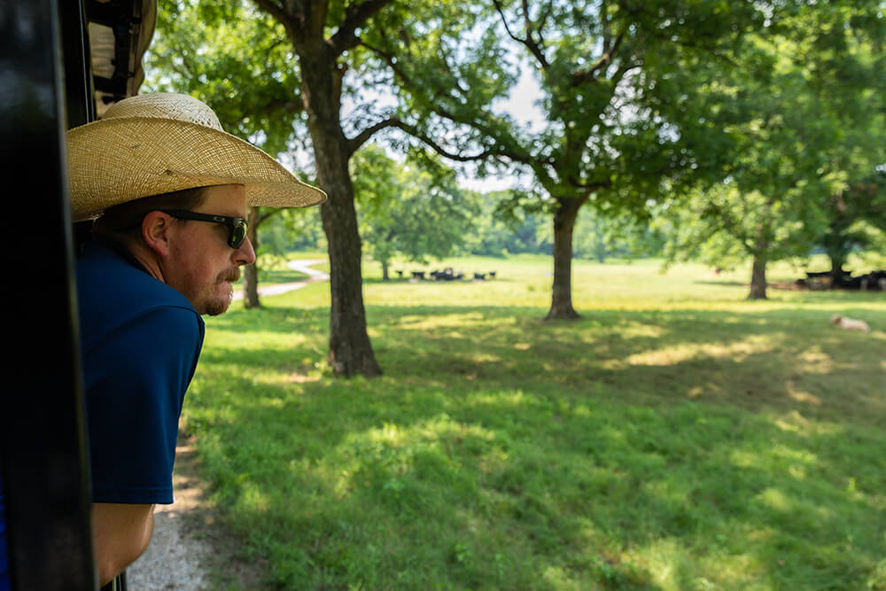Joe Pokay looks out over the wooded pastures of Noble's Red River Ranch