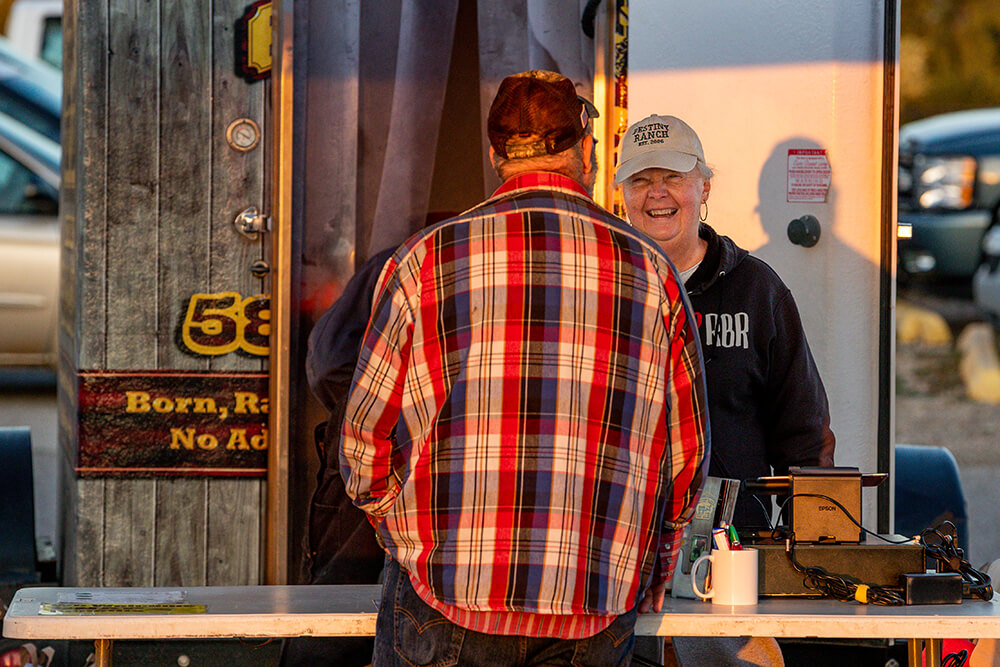 Karen Payne talks with a customer at the Destiny Ranch Beef sales trailer.