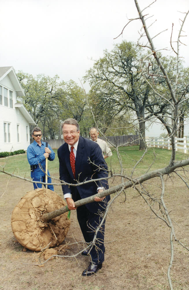 Mike Cawley helps plant a tree at the Noble Research Institute Farmhouse