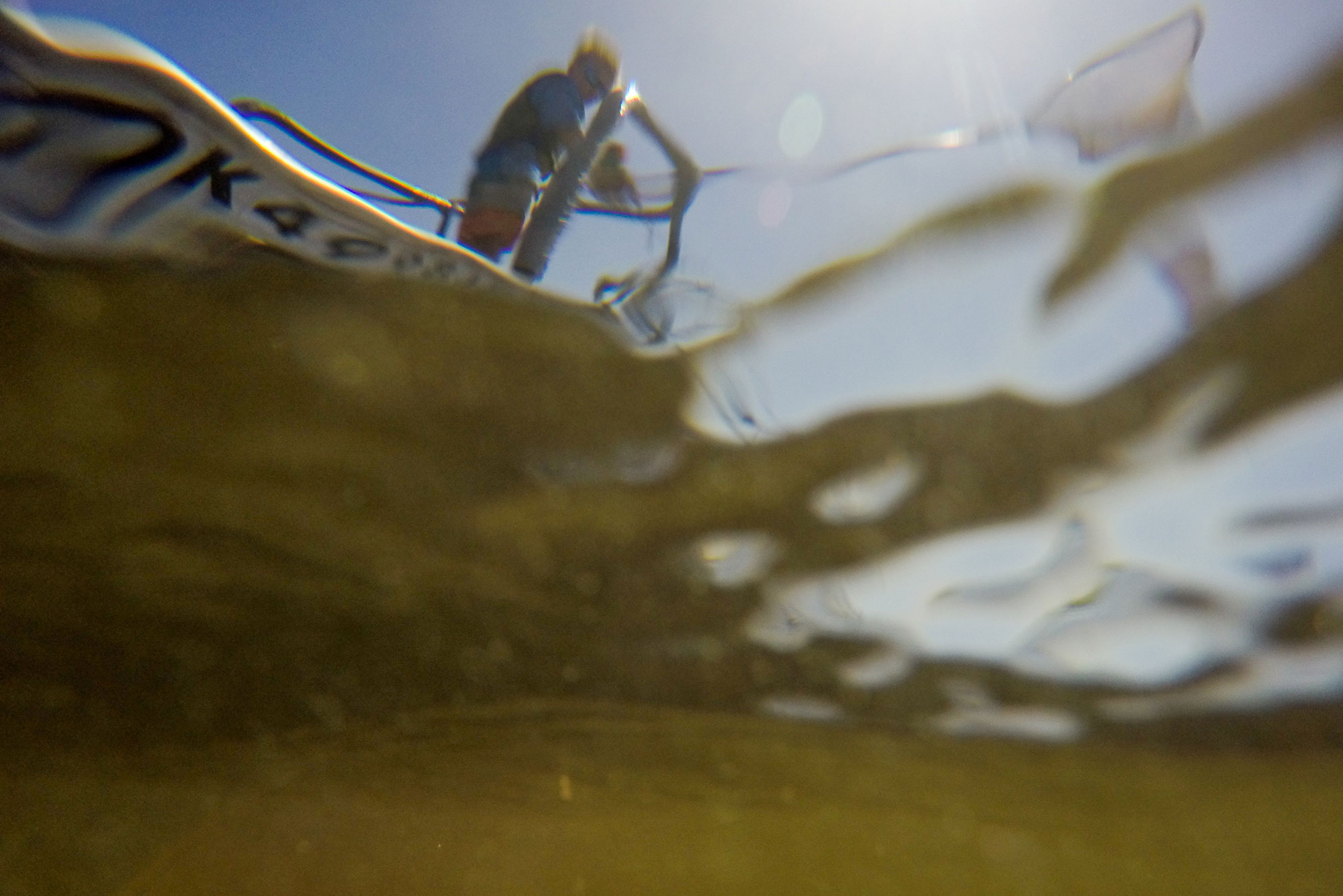 Underwater shot of a fisherman in a boat