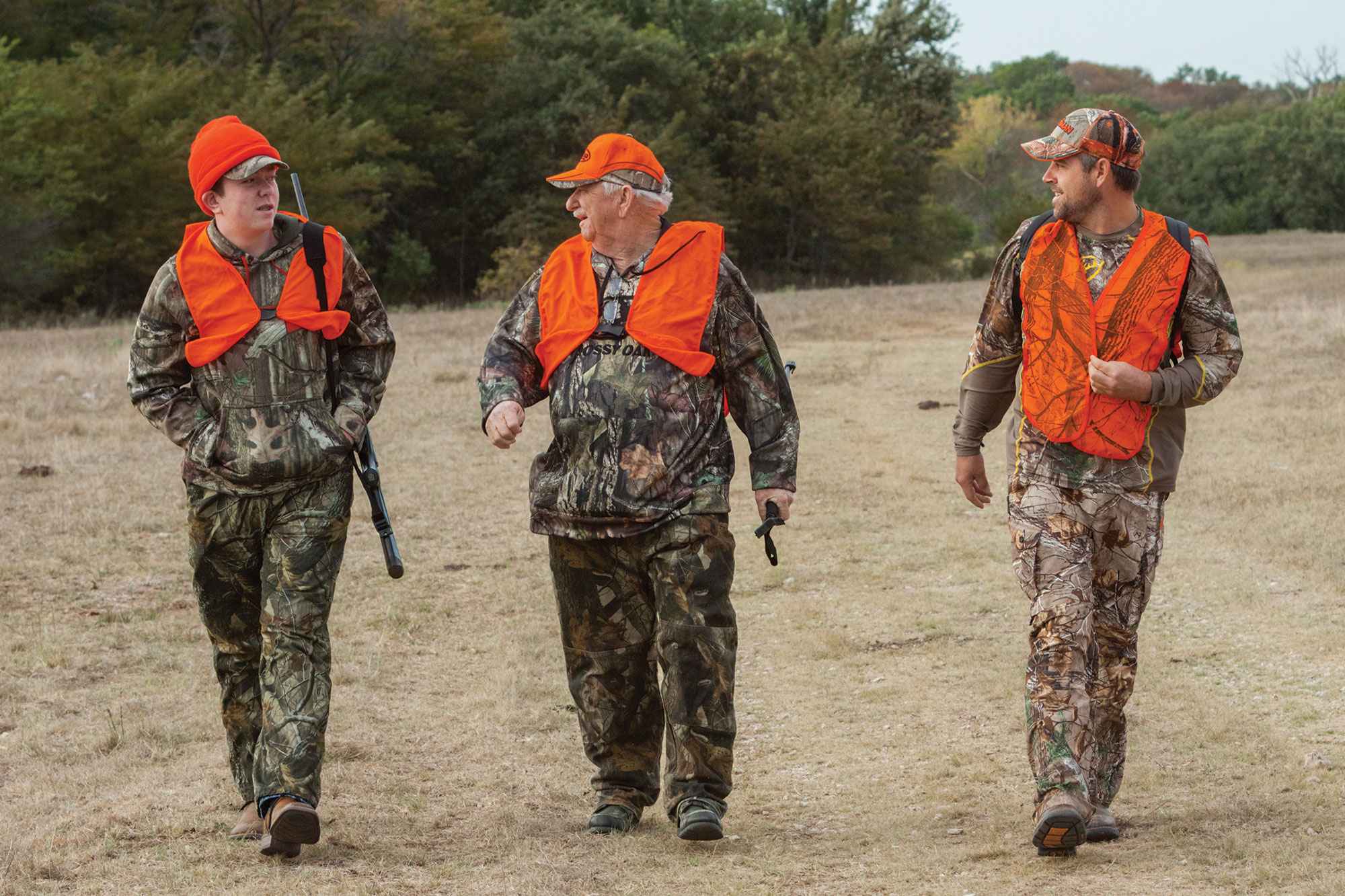 Hunters in camoflage and orange safety vests.
