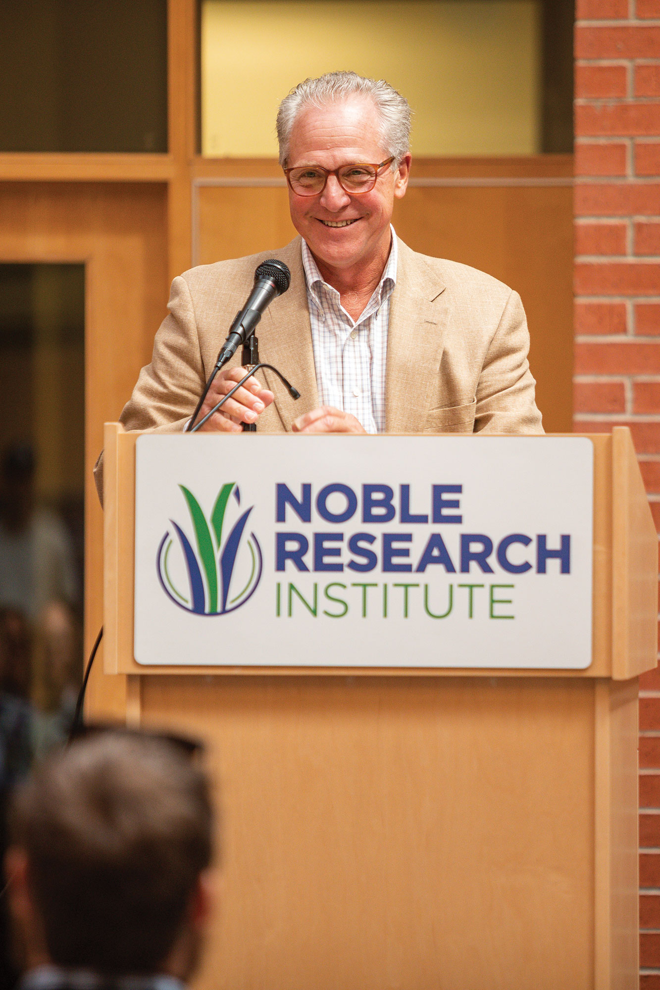 Bill Buckner speaking in front of Noble Research Institute employees
