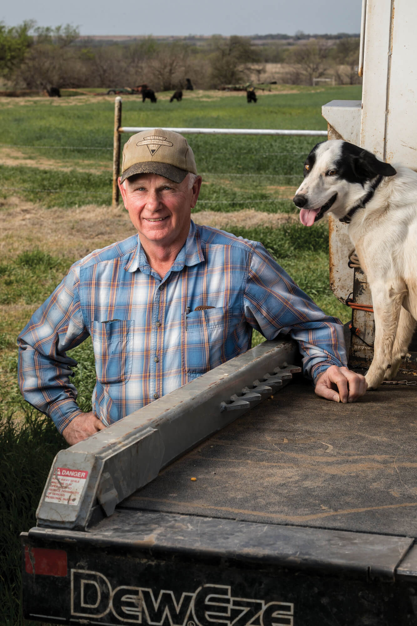 Lee Wayne Stepp and his border collie, Abbie, rest at the bed of his truck.