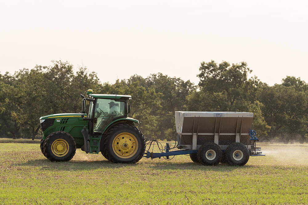 Tractor spreading solid nitrogen fertilizer