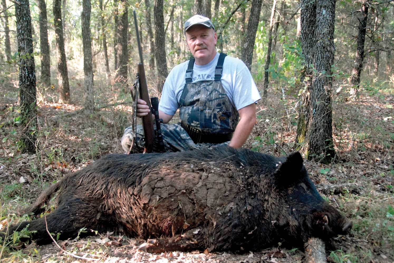 Hunter with feral hog 