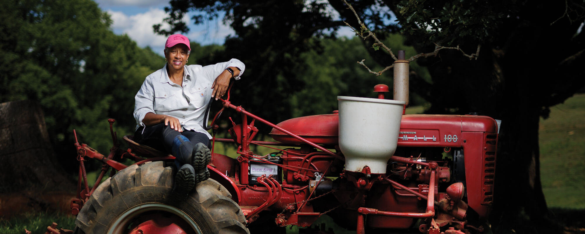 Sustainable farmer Beverly Bowen relaxes for a moment on her 1954 McCormick Farmall, the same model she grew up using as a girl on the farm she and her brother run today.