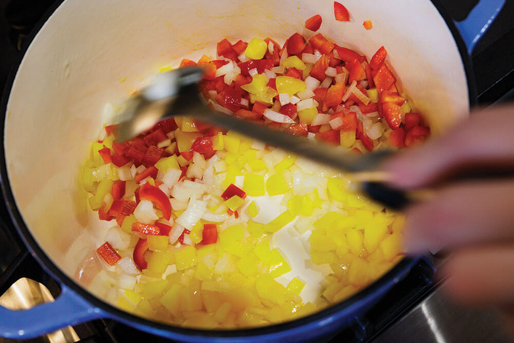 Mixing beef fajita soup ingredients