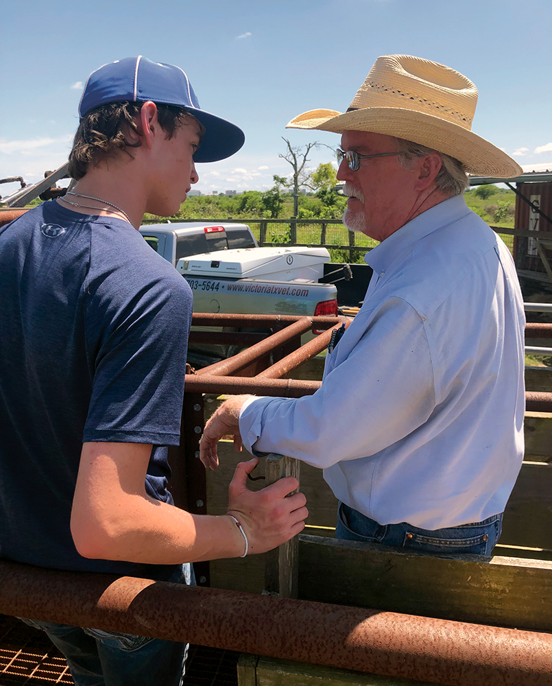 Vance Mitchell and Grandson next to squeeze chute
