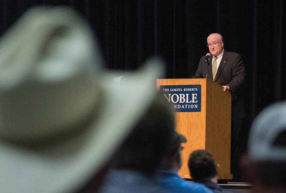 Rusty Noble, a grandson of founder Lloyd Noble, speaks to employees during the announcement at their all employee meeting.
