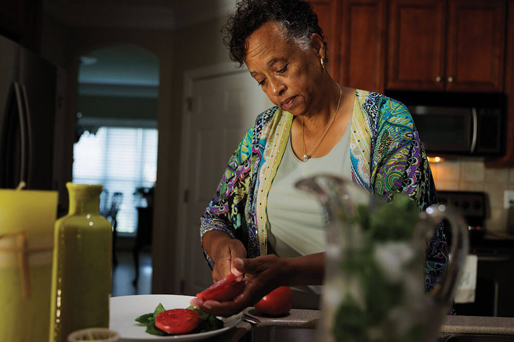 Beverly Bowen slices tomatoes