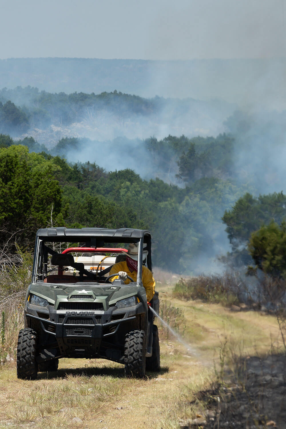 Rancher conducts burn in side-by-side ranch vehicle