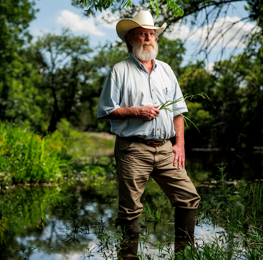 farmer standing in pond